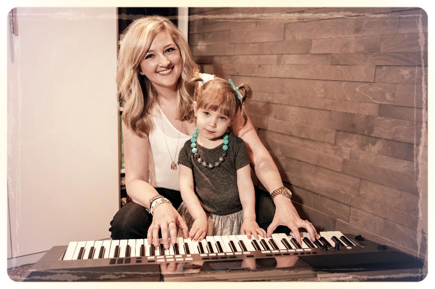 Alison Seipp playing keyboard with her daughter Clara.